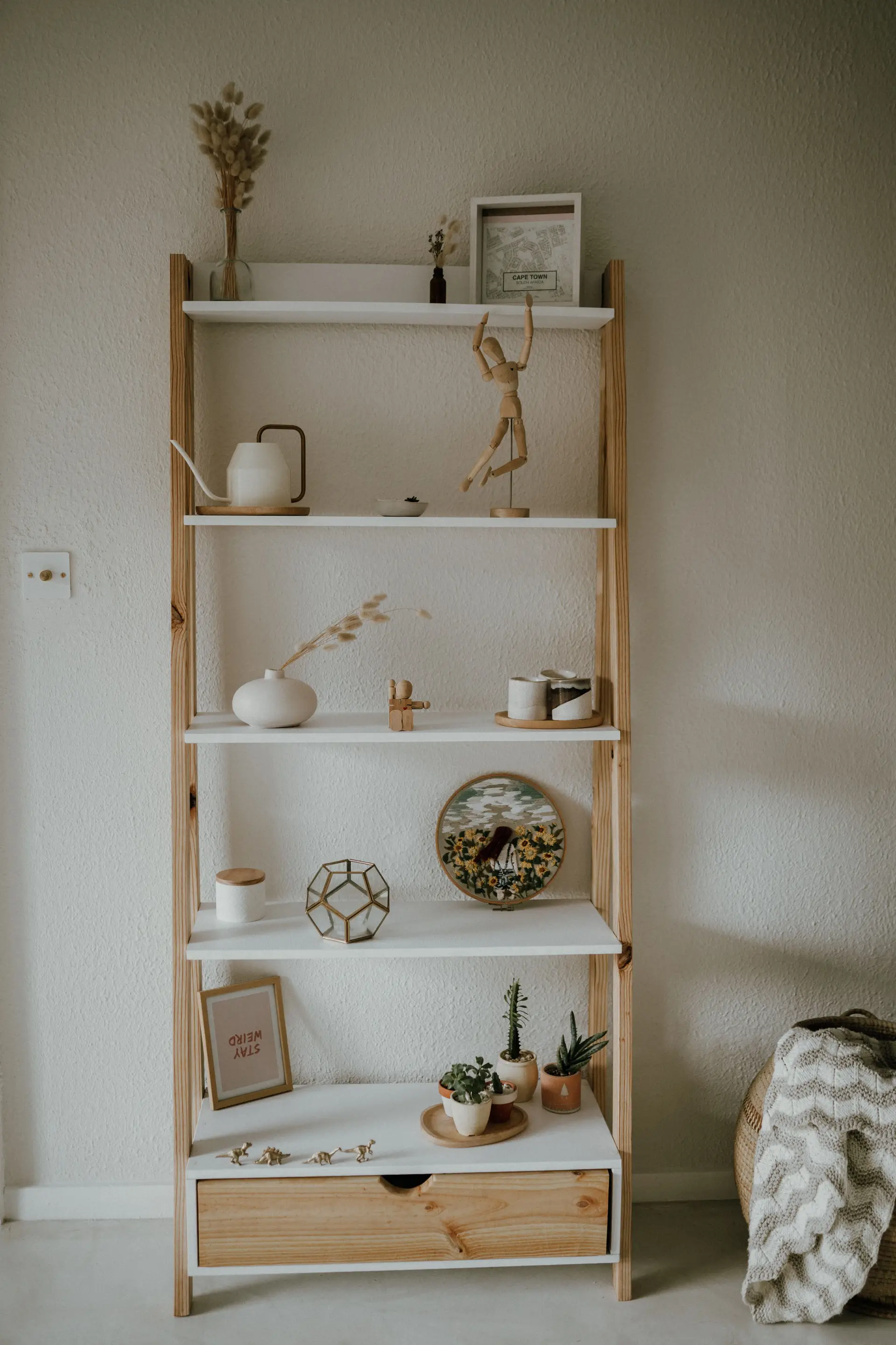 Minimalistinen avohyllykkö ja viherkasvit makuutilassa